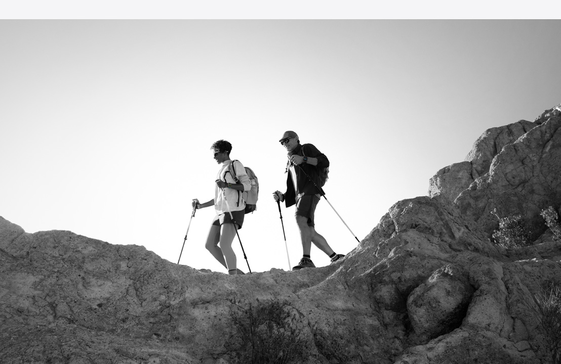 Two people wearing Lipagas Vertical Models Ultra 3 hike a mountain trail